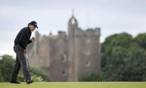 a man standing in a field with a castle in the background at Ard Garraidh in Ardersier