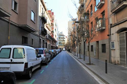 a city street with cars parked on the side of the road at Hostal Bejar in Barcelona
