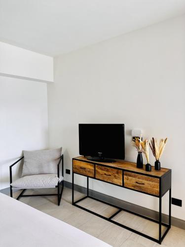 a living room with a tv and a chair at Domo s'Altura in Porto Rotondo