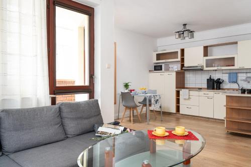 a living room with a couch and a table at LeoApart in Wrocław