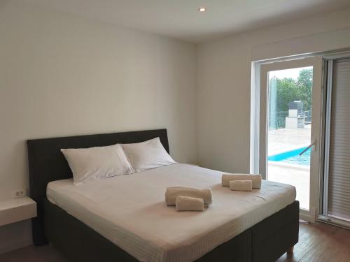 a bedroom with a bed with two towels on it at Villa Mare e Monti with heated pool in Umag