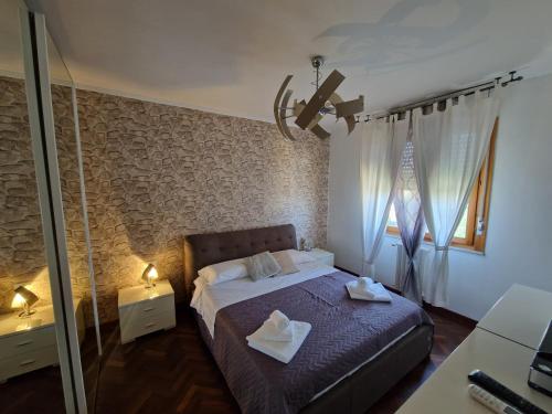a bedroom with a bed with two towels on it at Miriam House Florence - full apartment - relax & comfort in Florence