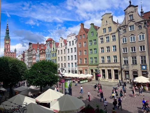 a group of people walking around a city with buildings at Holiday Apartment Old Town Gdansk with a Jacuzzi in Gdańsk