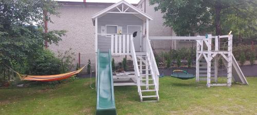 a play house with a ladder and a slide at Apartamenty Defala i Strefa Relaksu Natural Touch in Rymanów-Zdrój