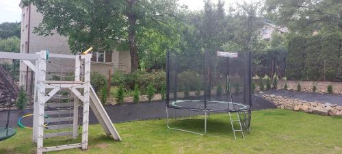 a playground with a trampoline at Apartamenty Defala i Strefa Relaksu Natural Touch in Rymanów-Zdrój