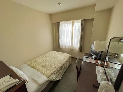 a hotel room with a bed and a window at Ichihara Marine Hotel - Vacation STAY 01289v in Ichihara