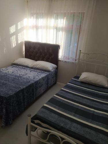 Postel nebo postele na pokoji v ubytování İNAN'S HOME