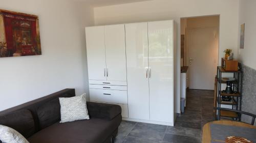 a living room with a couch and a white cabinet at Neptun 501 in Balatonföldvár
