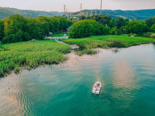 a small boat in the middle of a river at Lotus Sapanca-Private Villa with private Pier and heated pool in Serdivan