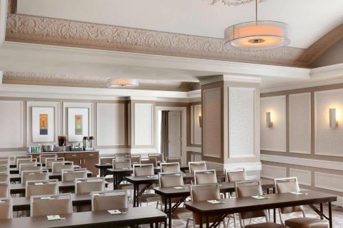 a large room with tables and chairs in it at Courtyard St. Louis Downtown/Convention Center in Saint Louis