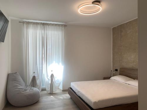 a bedroom with a bed and a large window at San Rocco Apartments in Riva del Garda