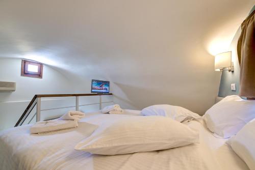 two white towels sitting on top of a bed at Ifestos Villa in Fira