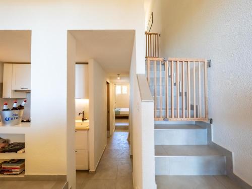 a stairway leading into a kitchen with a stair case at Casa Flaminia Villasimius in Villasimius