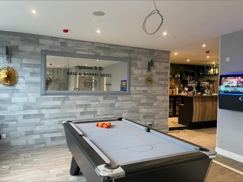 a pool table in a room with a bar at The Brig & Barrel hotel in Buckie
