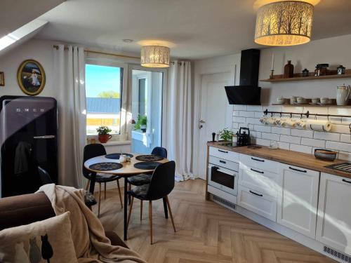 cocina con mesa y sillas en una habitación en Apartament Cztery Strony Mazur, en Ryn