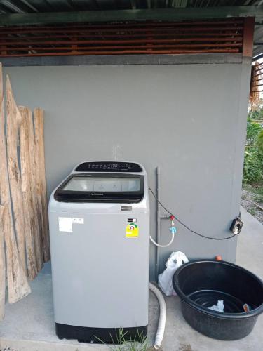 a water heater sitting under a building next to a bucket at สุขเสมอ โฮมสเตย์ (Suk-Samer homestay) in Ban Nong Phao Than