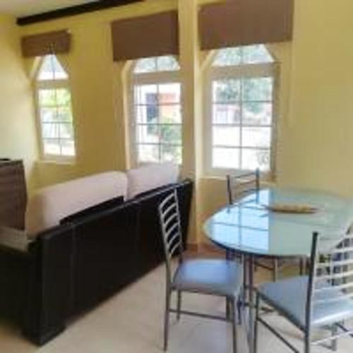 a dining room with a table and chairs and windows at Charming Studio with Pool, Mountain View in Monchique, 50sqm in Monchique