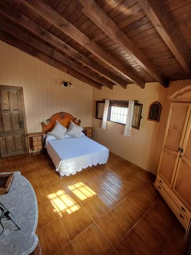 a bedroom with a bed and a wooden floor at Casa VistaBahía in Málaga