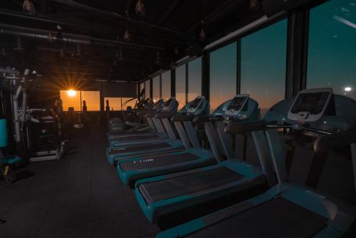 a row of rows of exercise machines in a gym at Carmel Hotel in Ramallah