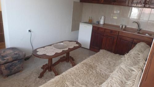 a small kitchen with a table and a couch in it at House Stefanovic 