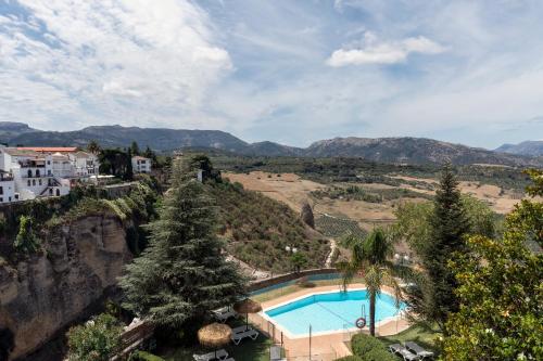 a resort with a swimming pool on a mountain at Parador de Ronda in Ronda