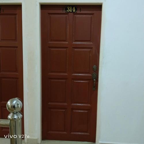 a brown door with the number on it at Flora Inn in Kota Bharu