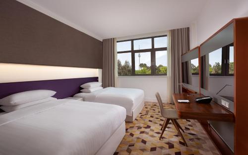 a hotel room with two beds and a desk at Sheraton Baku Intourist in Baku