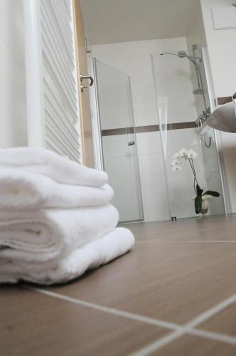 a pile of towels on the floor of a bathroom at Beierleins Hotel & Catering GMBH in Reichenbach