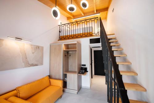 a living room with a couch and a staircase at Solvio Boutique Hotel & Spa in Lefkada Town
