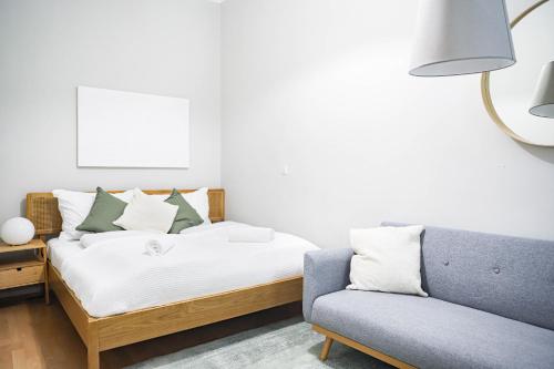 - une chambre avec un lit et un canapé dans l'établissement Spacious Apartment, 3 min to U1 Reumannplatz, à Vienne