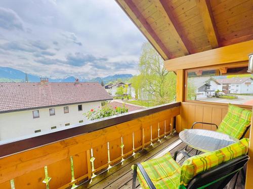a porch with a table and chairs on a balcony at Haus Eggensberger in Fischen