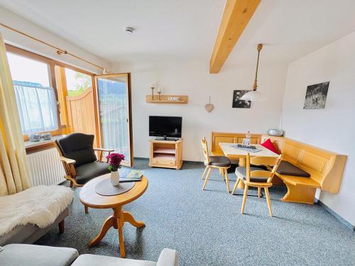 a living room with a couch and a table at Haus Eggensberger in Fischen