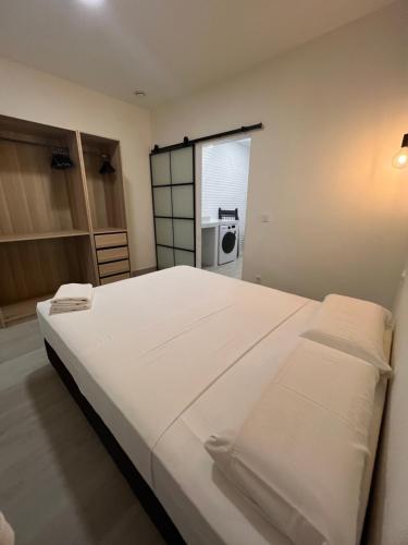 a large white bed in a room with a microwave at APARTAMENTOS PLAYA VALENCIA in Valencia