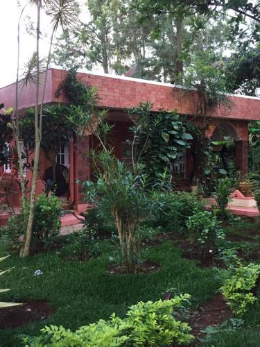 a house with a garden in front of it at Yelagiri Villa in Yelagiri
