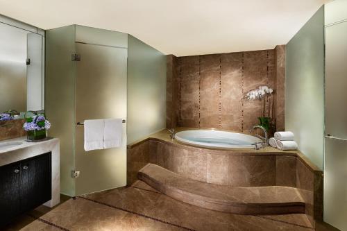 a bathroom with a tub and a sink at Sands Macao in Macau