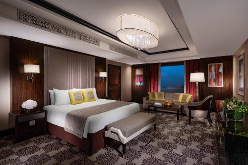 a hotel room with a large bed and a couch at Sands Macao in Macau