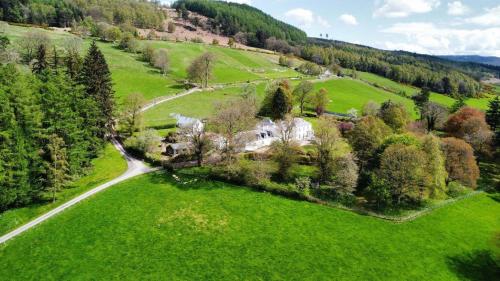 an aerial view of a house in a green field at The Stables in Pitlochry
