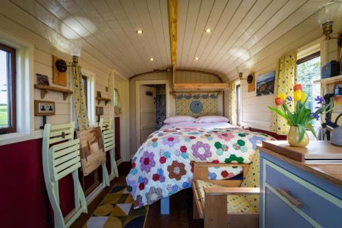 a bedroom in a tiny house with a bed at Dotties Retreat in Combe Martin