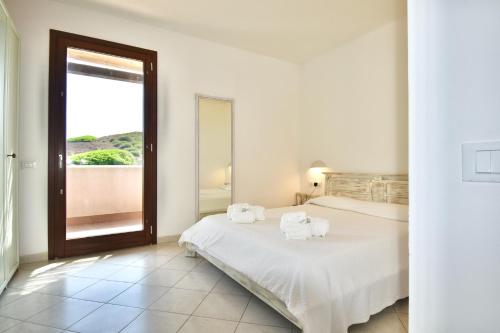 a bedroom with a bed with towels on it at Kuddie Rosse Eco-Friendly Residence in Pantelleria