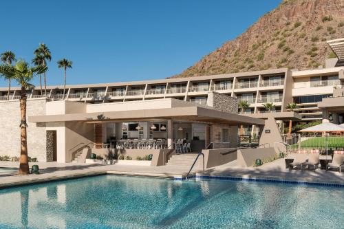 a hotel with a swimming pool in front of a mountain at The Phoenician, a Luxury Collection Resort, Scottsdale in Scottsdale