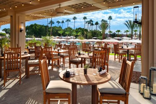 a restaurant with tables and chairs and a view of the ocean at The Phoenician, a Luxury Collection Resort, Scottsdale in Scottsdale