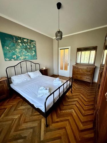 a bedroom with a bed and a wooden floor at Casa Vittorio in Turin