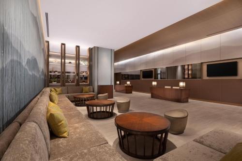 a lobby with a couch and some tables and chairs at The Westin Miyako Kyoto in Kyoto