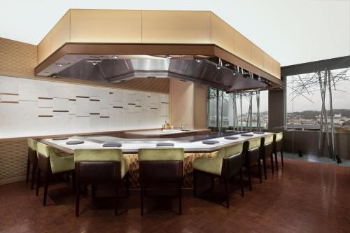 a kitchen with a large island with bar chairs at The Westin Miyako Kyoto in Kyoto