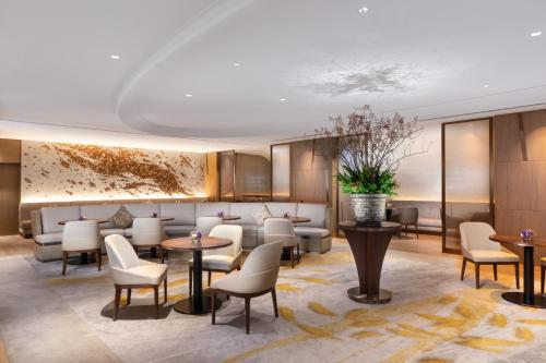 a lobby of a hotel with tables and chairs at The Westin Miyako Kyoto in Kyoto