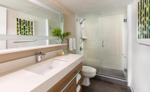 a bathroom with a sink and a shower and a toilet at Amara Cay Resort in Islamorada