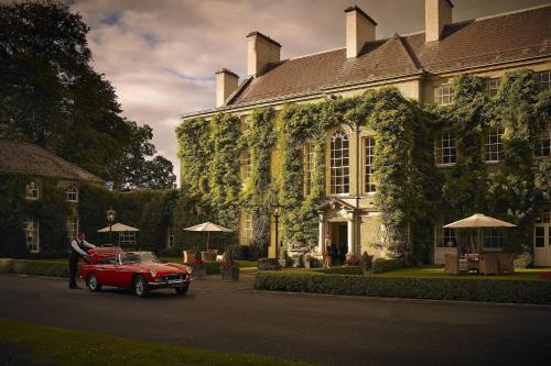 a red car parked in front of a building at Mount Juliet Estate, Autograph Collection in Thomastown