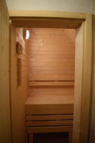 a wooden sauna with a bench in the middle at Penzión na gazdovskom dvore in Dolný Kubín