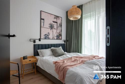 a bedroom with a bed with a blanket on it at Hawaje apartament przy plaży - 365PAM in Sianozety