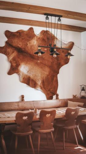 a dining room with a wooden table and chairs at Toni Hütte am Riesserkopf in Garmisch-Partenkirchen
